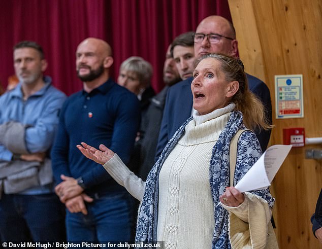 A woman asks questions at the event on Thursday night