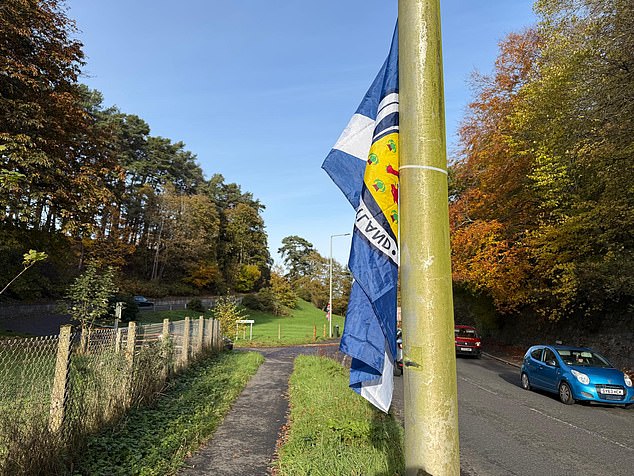 A saltire hanging on a lamppost on the road leading to Cameron Barracks