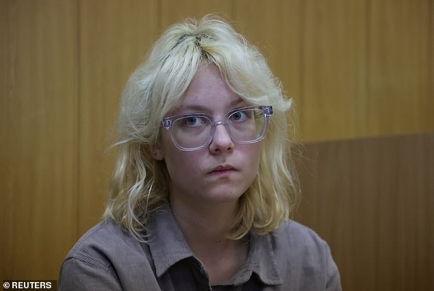 Diana Loginova, an 18-year-old street musician was jailed for 13 days after publicly singing a song banned by the government as 'extremist' in front of a crowd of fans. Pictured: Loginova sits in a courtroom before a hearing in Saint Petersburg, Russia October 16, 2025