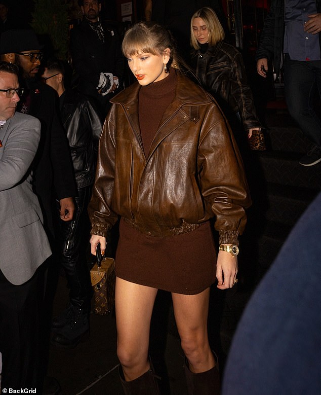 Bright red lipstick popped against the neutral tones of her outfit, drawing attention to her radiant smile