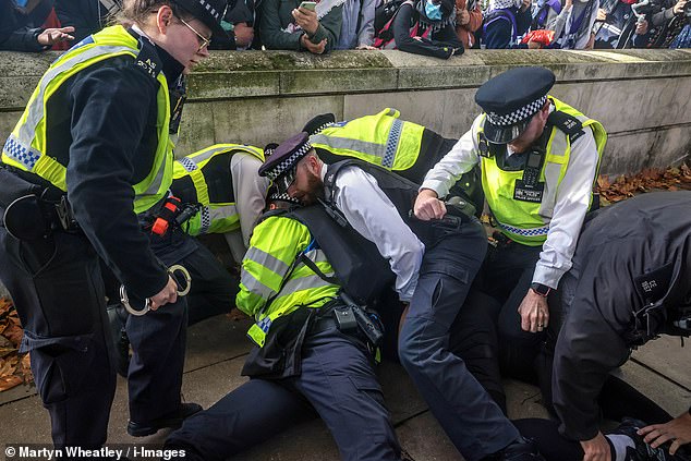 LONDON: Police take an individual into custody at today's march