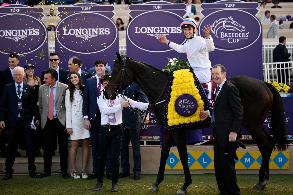 Dylan McMonagle on horseback celebrating after winning the Breeders' Cup Turf race, surrounded by people and falling confetti.