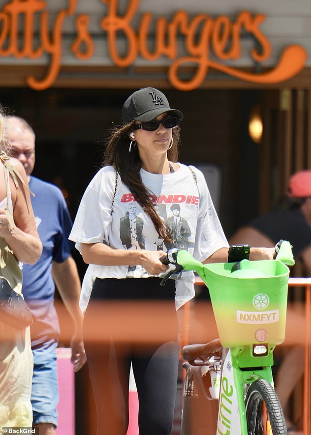 She was dressed casually for the outing in black sport tights, a white T-shirt and a pair of comfortable sneakers