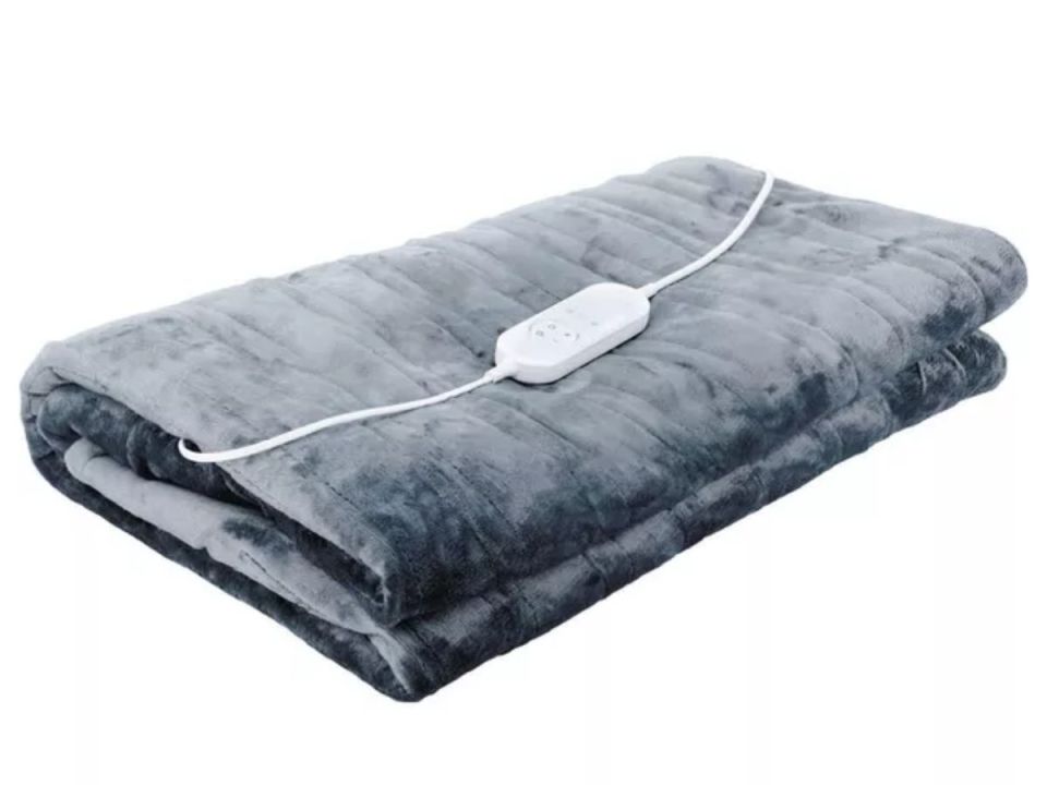Folded grey electric blanket with a white cord and remote.