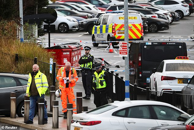 Police officers and emergency personnel work at the scene on Sunday morning following the mass stabbing on Saturday evening