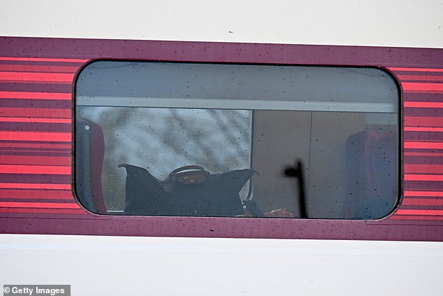 A passengers belongings are seen through the window as emergency services attend to Huntingdon Station on November 2