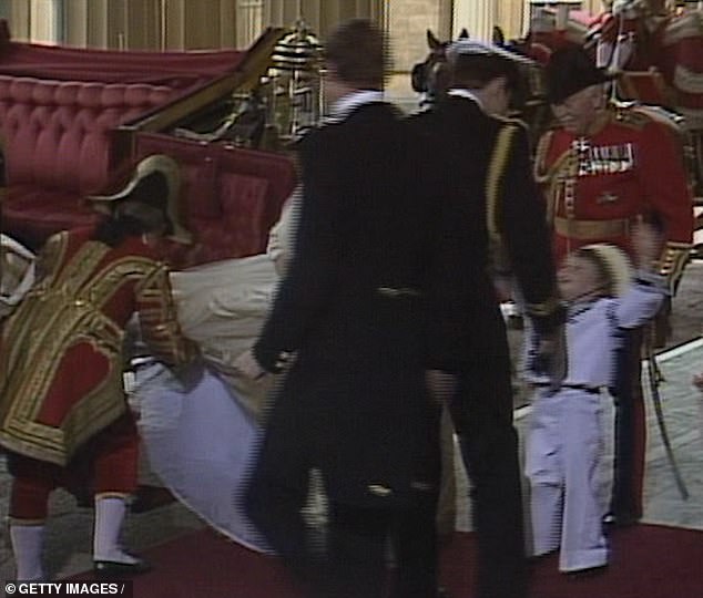 Upon the bride and groom's return to Buckingham Palace following their ceremony, a four-year-old William, who served as a page boy at the nuptials, was filmed leaping with excitement into his uncle's arms before the pair shared a sweet hug (pictured)