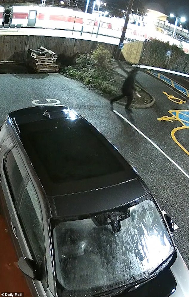 New footage shows a knifeman carrying a blade while walking through a car park next to Huntingdon rail station in Cambridgeshire following Saturday night's train stabbings