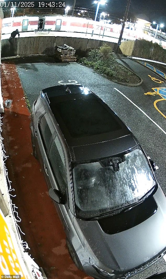 The black-clad man then vaulted a fence before continuing to walk on while carrying a blade