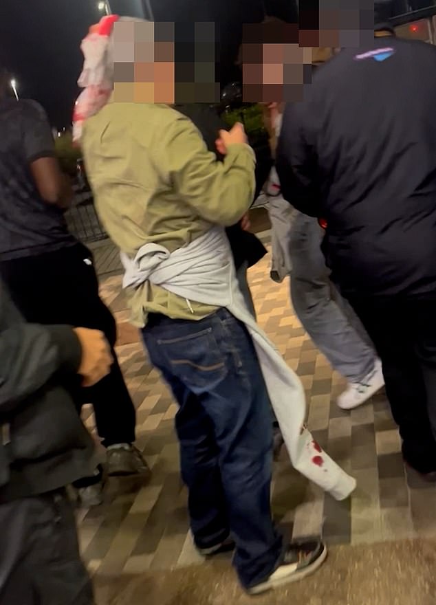 In a video, one man held a rag to his head as crimson-coloured blood seeped through