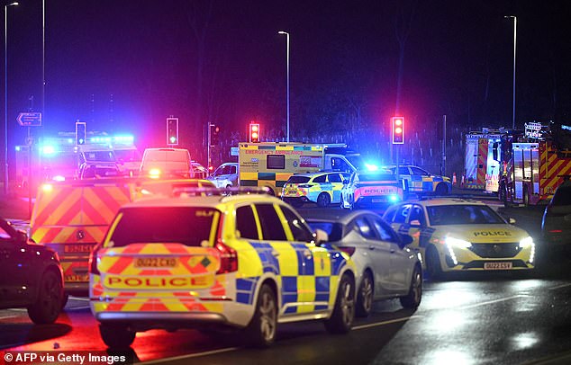 Police cars and ambulances pictured outside Huntingdon Station in Cambridgeshire