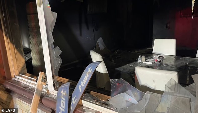 Shocking photos and video show LAFD responding to the fiery destruction, with the house having broken windows