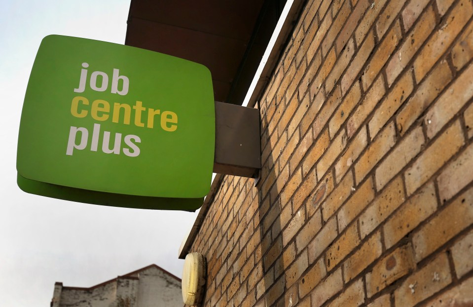 Jobcentre Plus sign on a brick building in East London.
