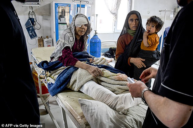 An Afghan injured woman receives treatment at a hospital in the aftermath of an earthquake, that struck overnight in Mazar-i-Sharif
