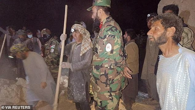 Rescuers work following the earthquake that has killed at least 20 people and injured 320 others