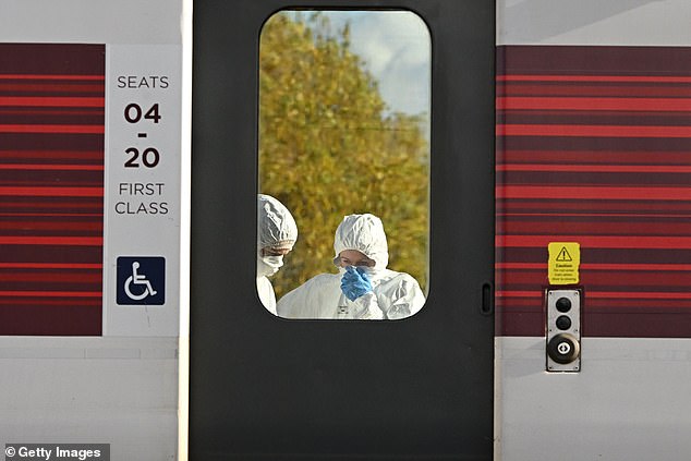 Police forensic officers examine the LNER Azuma train on Sunday following Saturday night's horror attack