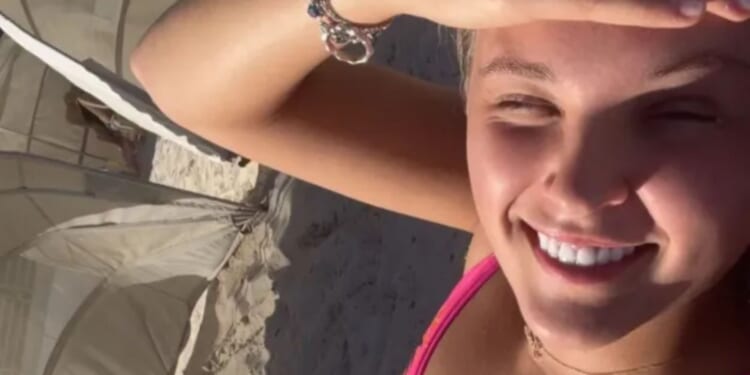 JoJo Siwa shares more sizzling holiday snaps as she strips to a tiny bikini and cosies up to Chris Hughes on a sunbed