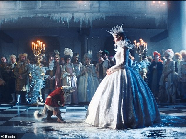 Puss presents the queen with a gift of hand warmers. She pauses to examine the handy present before instructing the room to 'dance'