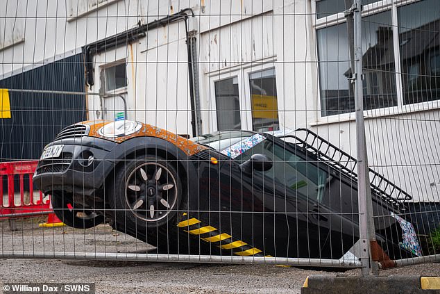 A council representative arrived to take photos of the scene, but it's not yet clear what the next steps will be or the extent of the car's damage