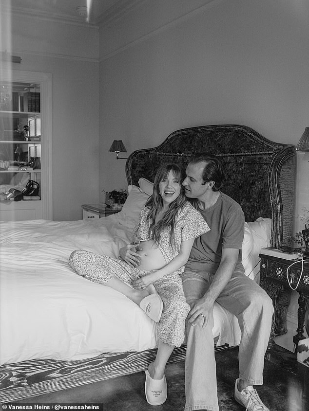 The newlyweds looks loved-up as they cradled her bump