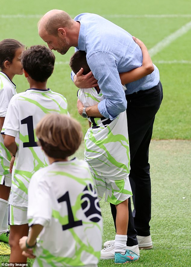 Prince William was seen hugging one of the children on the pitch