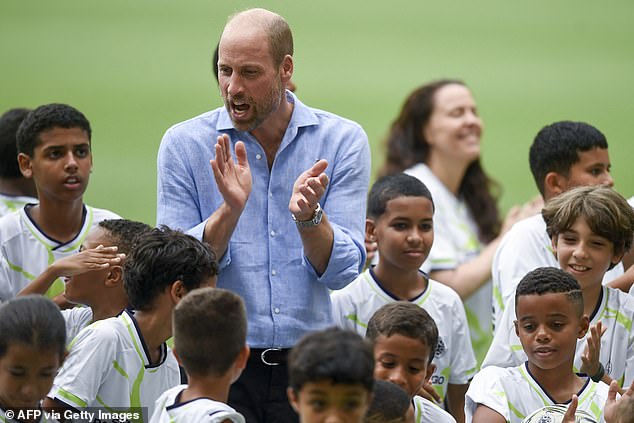 Britain's Prince William, Prince of Wales, applauds during the "Community Football" event with children who are part of social projects, at Maracana Stadium