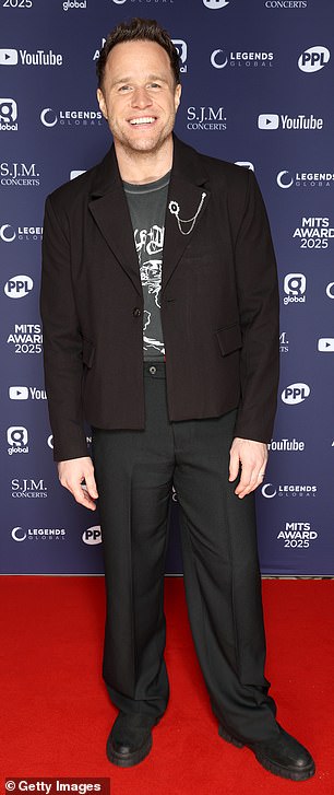 His pal and singer Olly Murs rocked a more low-key ensemble in a grey T-shirt and black jacket