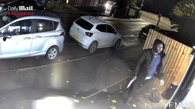 The man is seen outside the shop holding what appears to be a knife - after being told to leave just minutes before