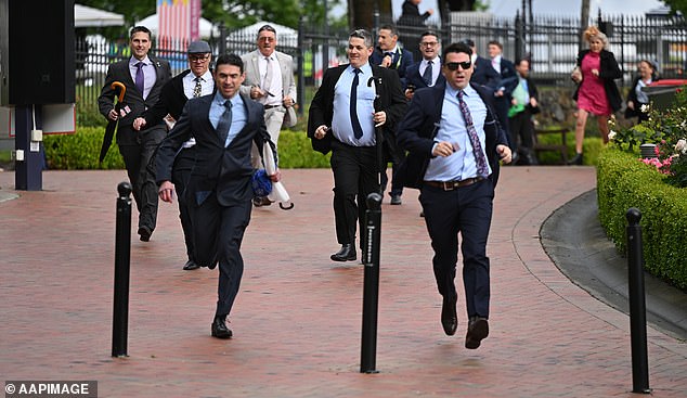 Racegoers run for position following the  gates opening to the 2025 Melbourne Cup Day at Flemington Racecourse in Melbourne, Tuesday, November 4, 2025. (AAP Image/James Ross) NO ARCHIVING, EDITORIAL USE ONLY
