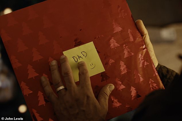 He unwraps the vinyl (pictured in the wrapping paper) and heads straight to his record player, with the ad cutting to him dancing in a 90s club before flashbacks show him remembering his son as a toddler and a baby