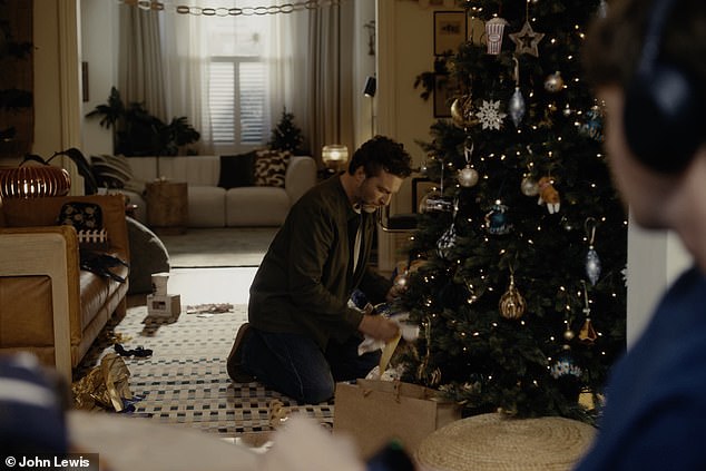 The ad, created by Saatchi & Saatchi, shows the father clearing up discarded wrapping and coming across an unopened present with a yellow sticky note marked 'Dad' with a smiley face