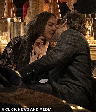 The lovebirds wrapped up warm as they dined alfresco in a swanky restaurant and enjoyed cocktails
