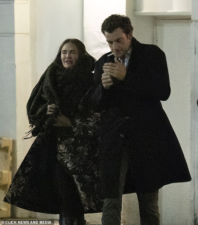 Nina wrapped a huge scard around her neck while Peregrine lit a cigarette