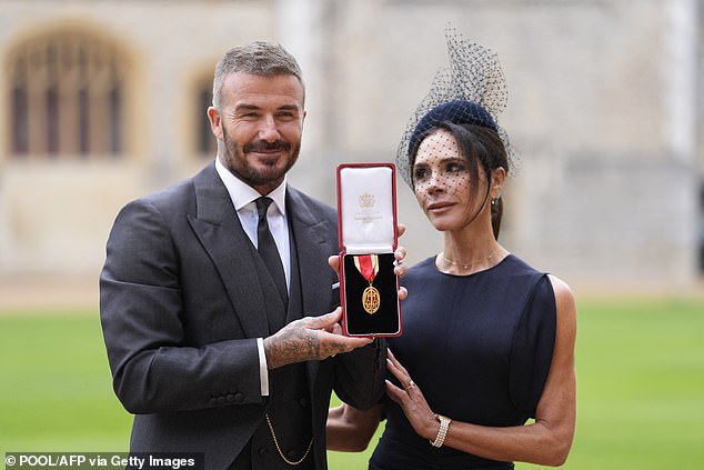 She paired the look with a netted fascinator which fell over her face