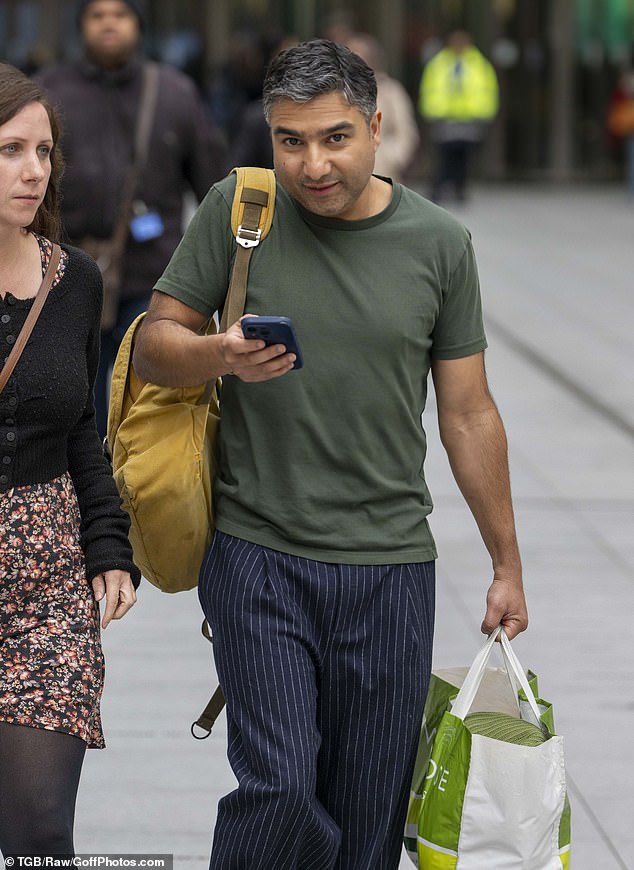 Nick Mohammed appeared glued to his phone as he arrived, appearing to carry his outfit in a Waitrose shopping bag