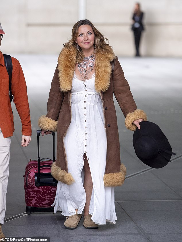 Charlotte Church could be seen in a white linen dress with a long brown coat as she dragged a suitcase behind her