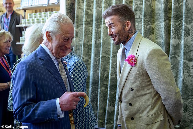 Sir David wearing a David Austin Roses 'King's Rose' as he speaks with King Charles at the RHS Chelsea Flower Show in May