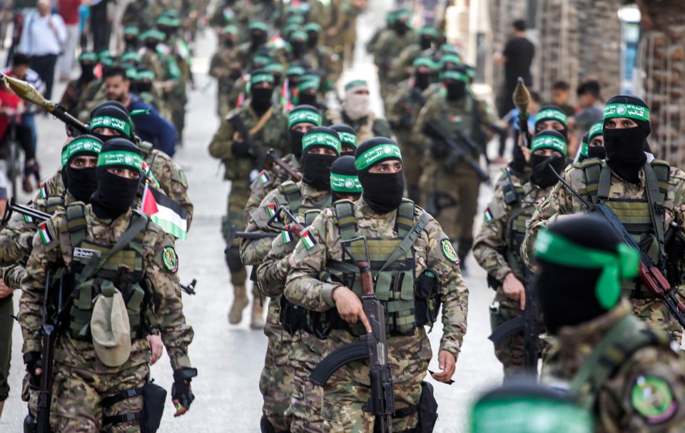 Members of the Ezz-Aldine Al-Qassam Brigades marching in a military parade.