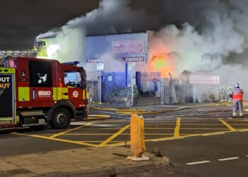 Dozens of firefighters battle huge industrial blaze as major tunnels shut and football fans told 'stay away'