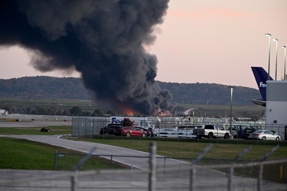 Thick black smoke rises from a plane crash at Louisville Muhammad Ali International Airport.