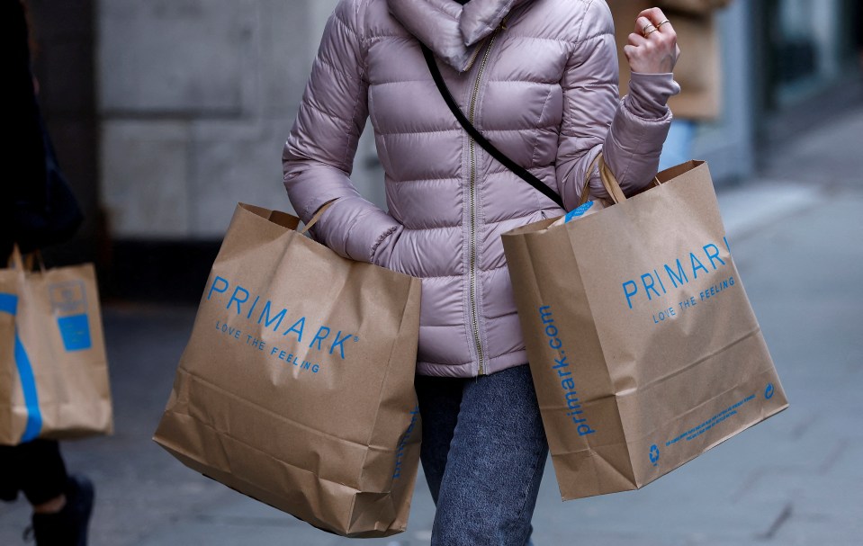 A woman carries Primark shopping bags on Oxford Street in London.