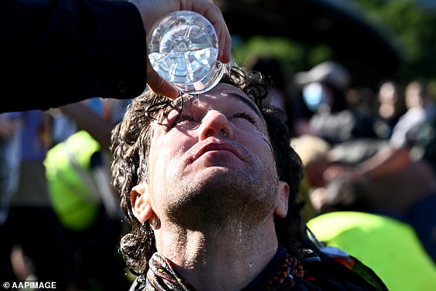 Police used pepper spray to break up the crowd, forcing protesters to wash their eyes out