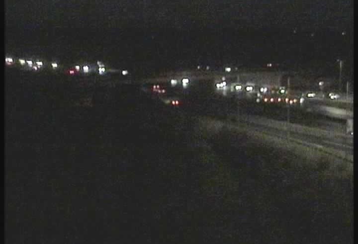 Nighttime view of a multi-lane highway with traffic, M4O.