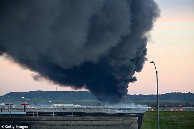 Fire and smoke mark where a UPS cargo plane crashed near Louisville Muhammad Ali International Airport on November 4, 2025 in Louisville, Kentucky