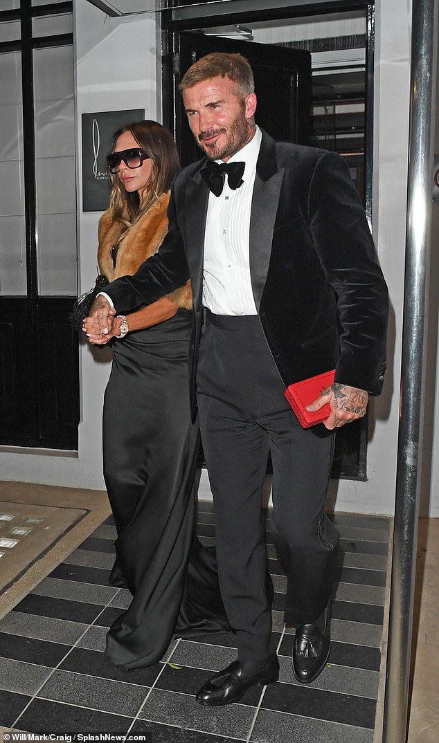 Lady Beckham had changed out of her smart navy dress worn at the day ceremony, opting for a slinky black floor length number and a fur bolero for the night's festivities