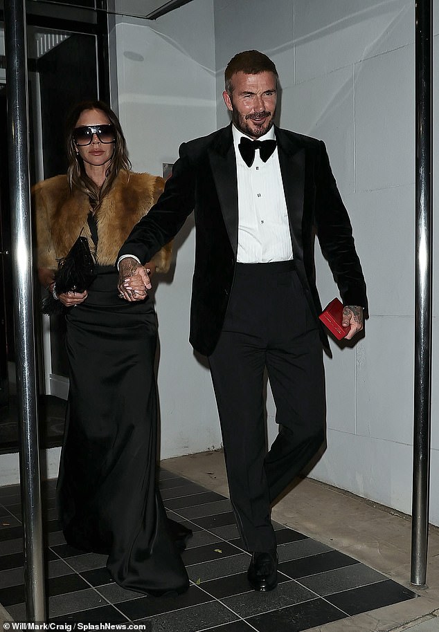 David couldn't bear to be parted from his investiture medal, holding onto his wife with one hand and the day's precious souvenir with the other