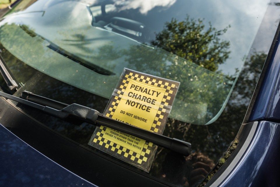 Close-up of a parking ticket placed on a cars windshield