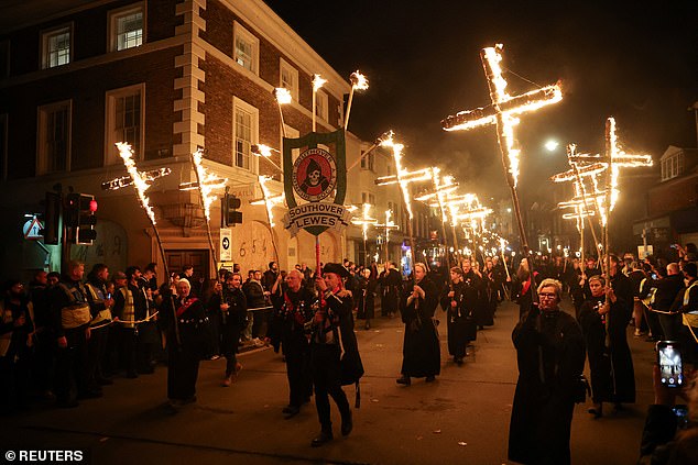 Participants of Lewes' famous annual Bonfire Night festivities parade through the town with flaming torches