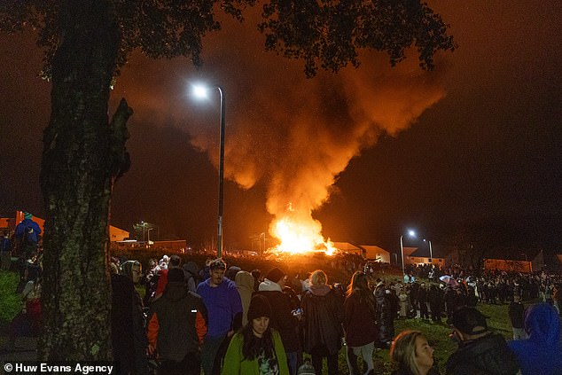 Pictured: a huge community bonfire and fireworks display in Penrhys, Rhondda Cynon Taff in South Wales