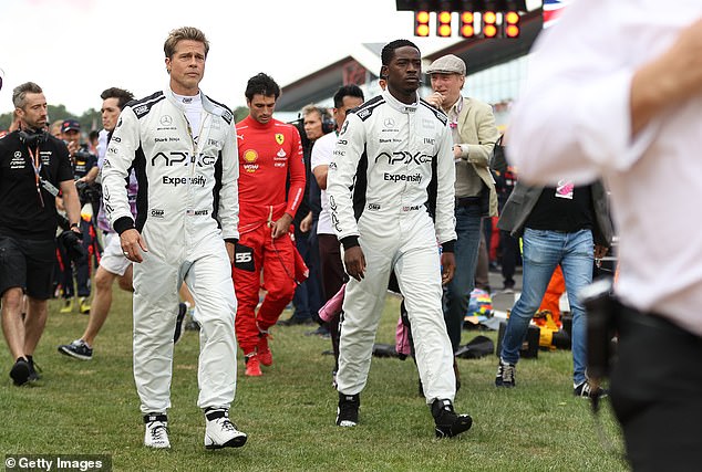 Idris pictured during filming for F1 alongside Brad Pitt at Silverstone in July 2023. The film was shot during real Formula 1 race weekends
